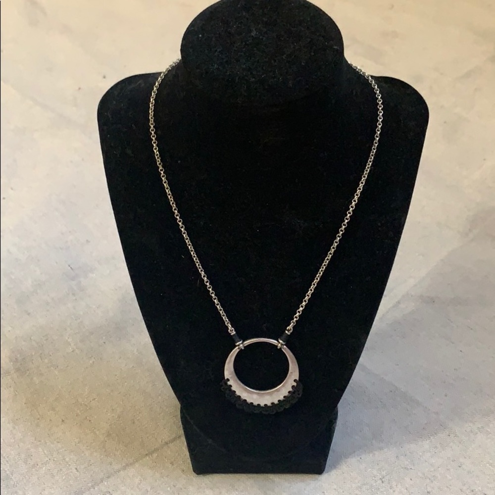 Silver and black crochet circular necklace.
